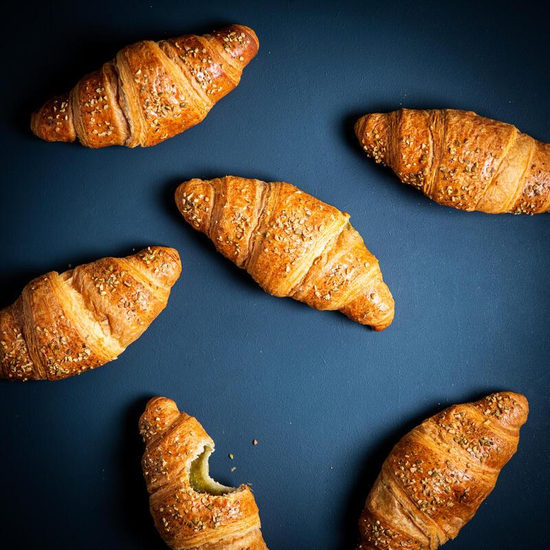 Pistachio filled croissant with pumpkin seed decoration
